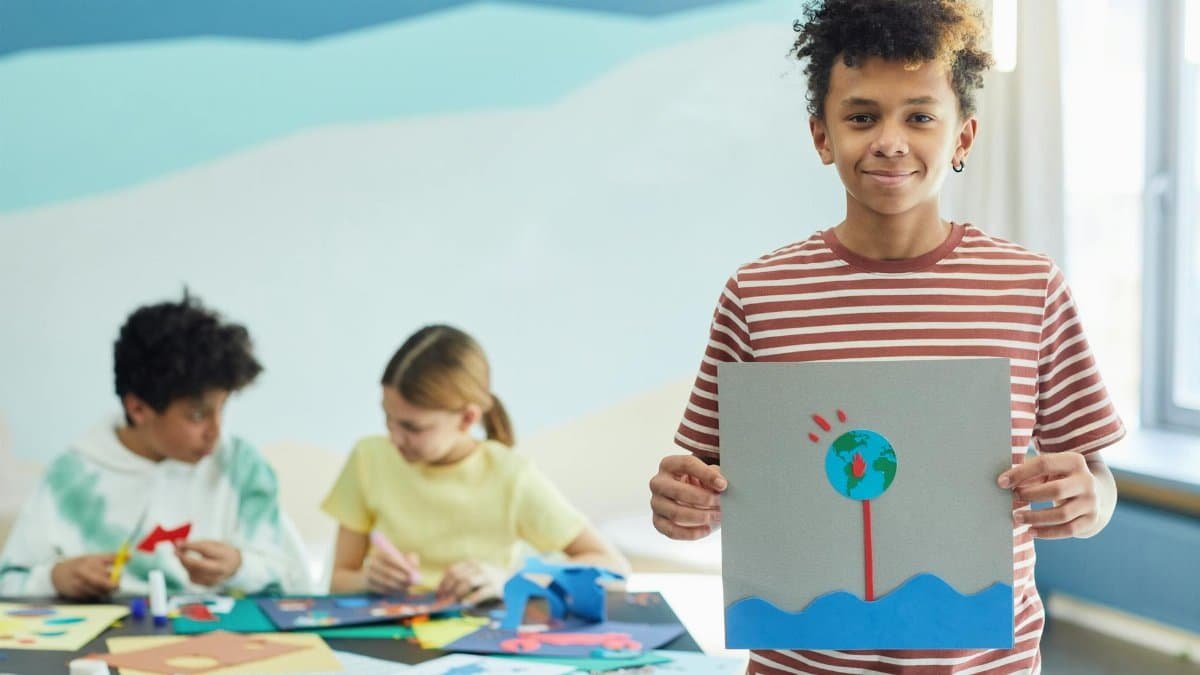 Children creating art projects in a classroom setting, showcasing creativity and teamwork.