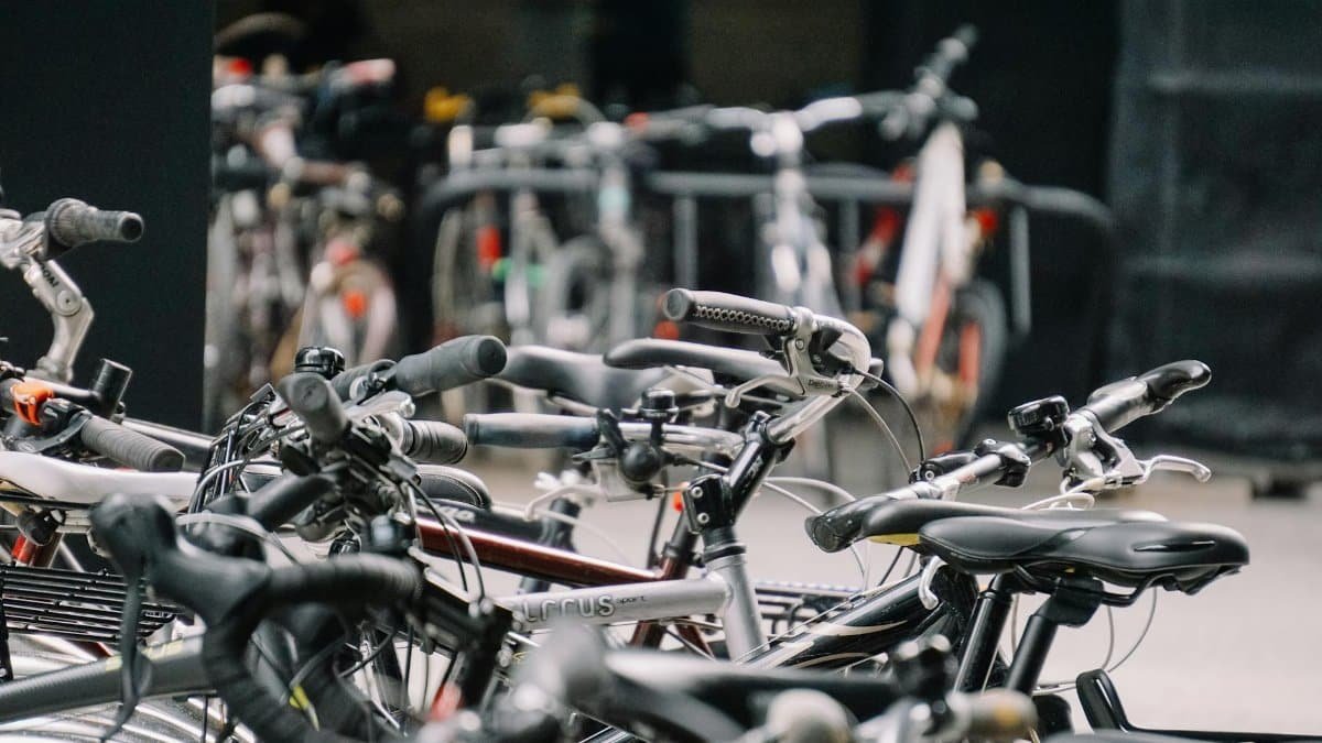 A busy urban bicycle parking lot with various bikes securely parked.
