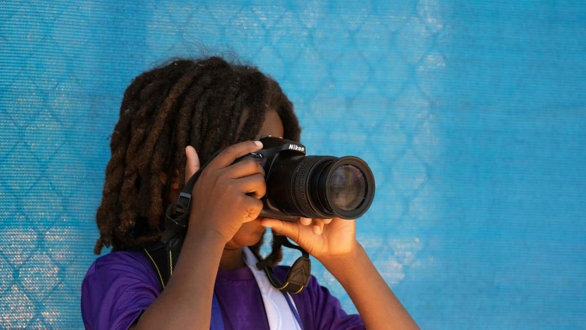 Kid holding Nikon Camera