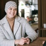Two women enjoying a heartfelt conversation in a cozy coffee shop, dressed warmly.