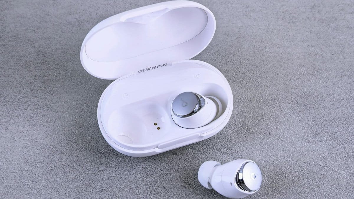 High-quality image of white wireless earbuds and charging case on a textured surface.