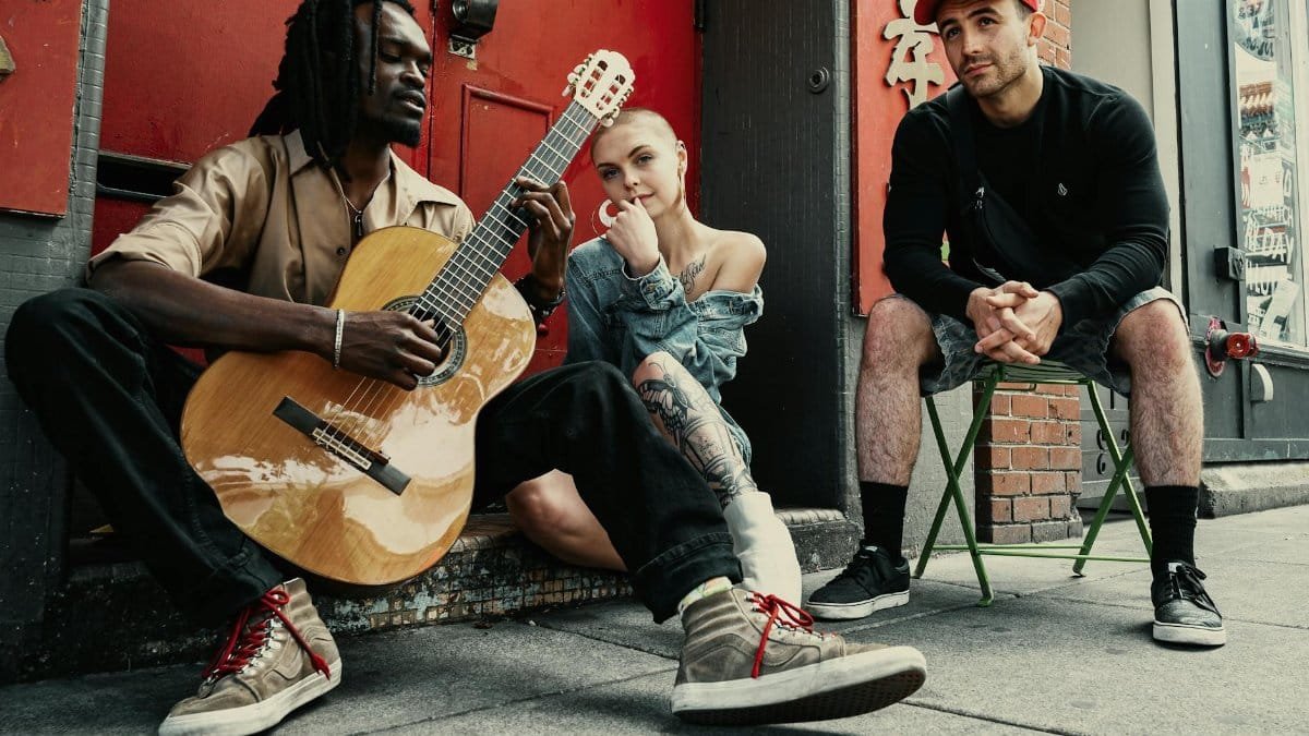 Diverse musicians perform on a city street, showcasing urban culture and friendship.