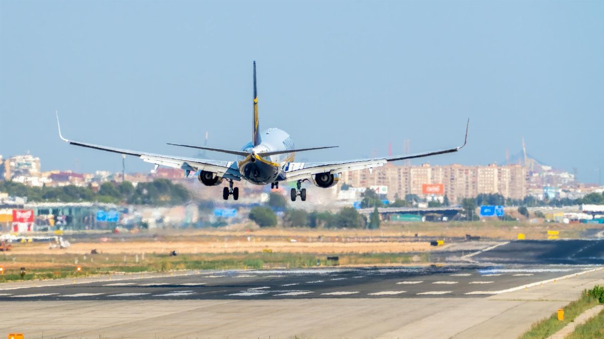 A commercial airplane making a final approach and landing at Valencia Airport, Manises, Spain.