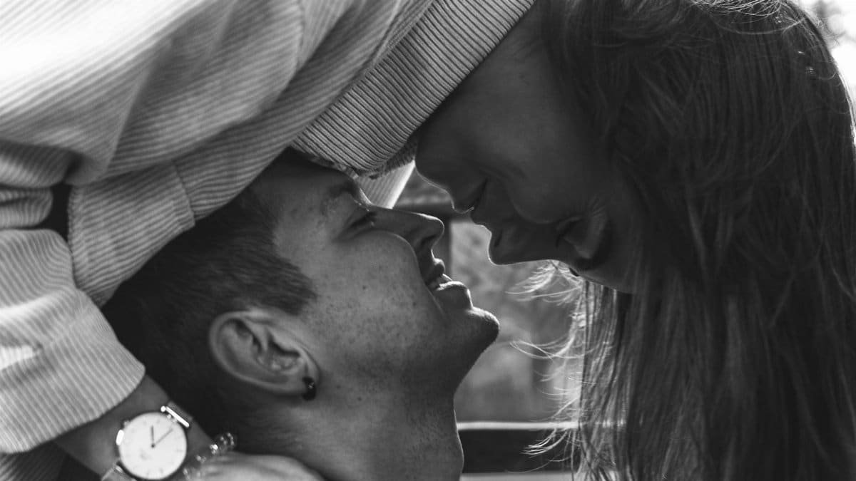 Intimate black and white portrait of a couple sharing a tender moment, evoking love and connection.