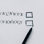 A minimalist image depicting the choice between balance and burnout with checkboxes.