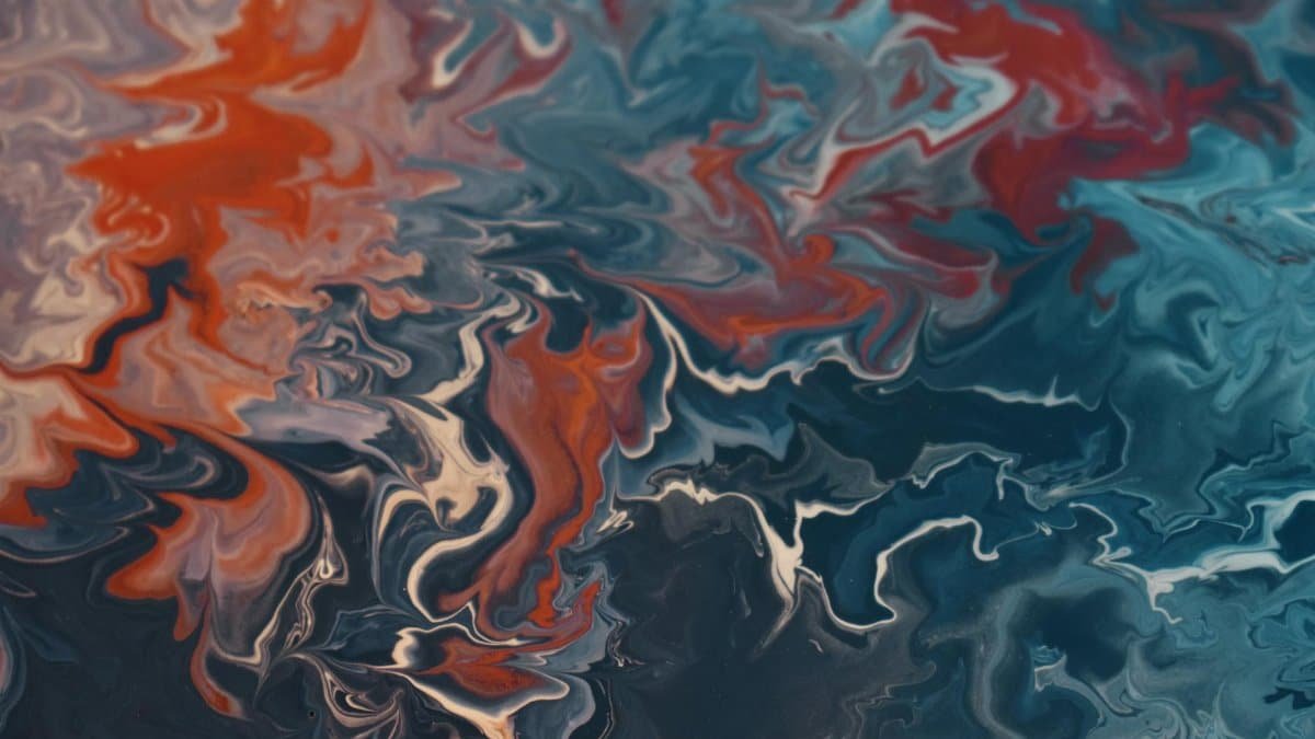 Dynamic abstract fluid art showcasing a vibrant mix of blues and reds creating energetic patterns.