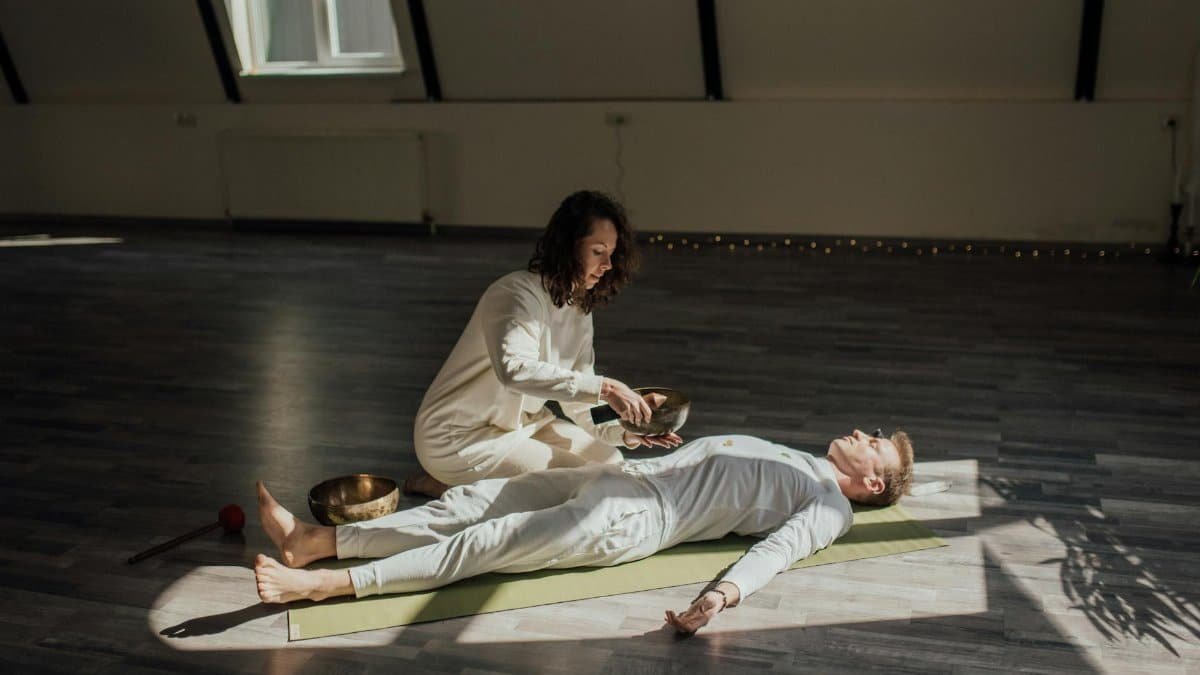 A serene meditation session with singing bowls for alternative healing indoors.