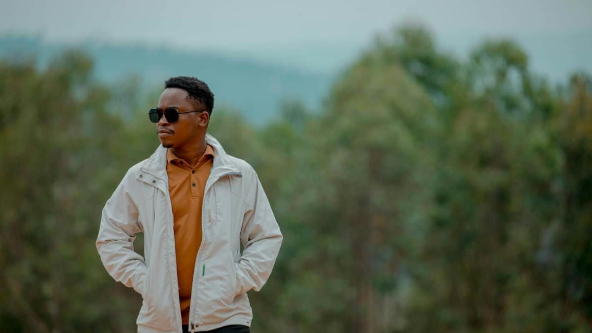 A stylish person with sunglasses enjoying a serene moment outdoors in Homa Bay, Kenya.