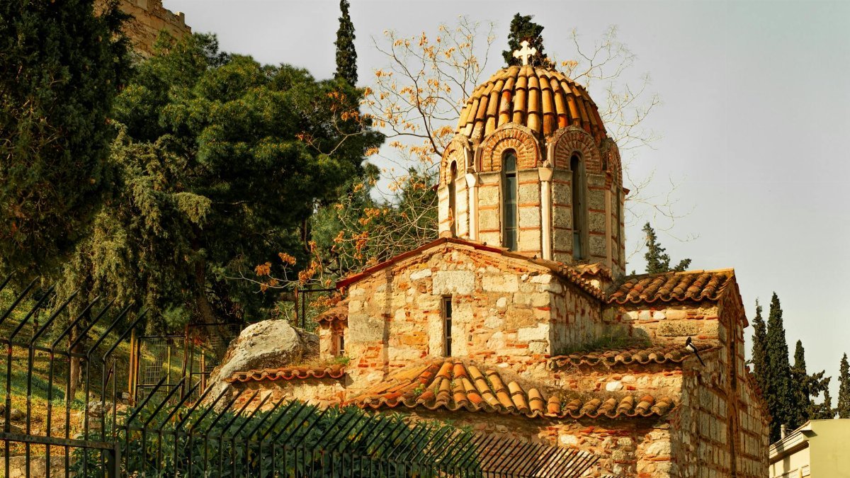 Ancient Byzantine church with traditional domed architecture in Athens, Greece.