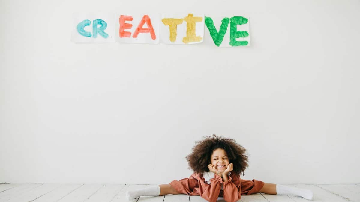Smiling child engaging in creative art with playful expression indoors.