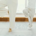 A mother and child practicing yoga indoors in a bright, calming room.