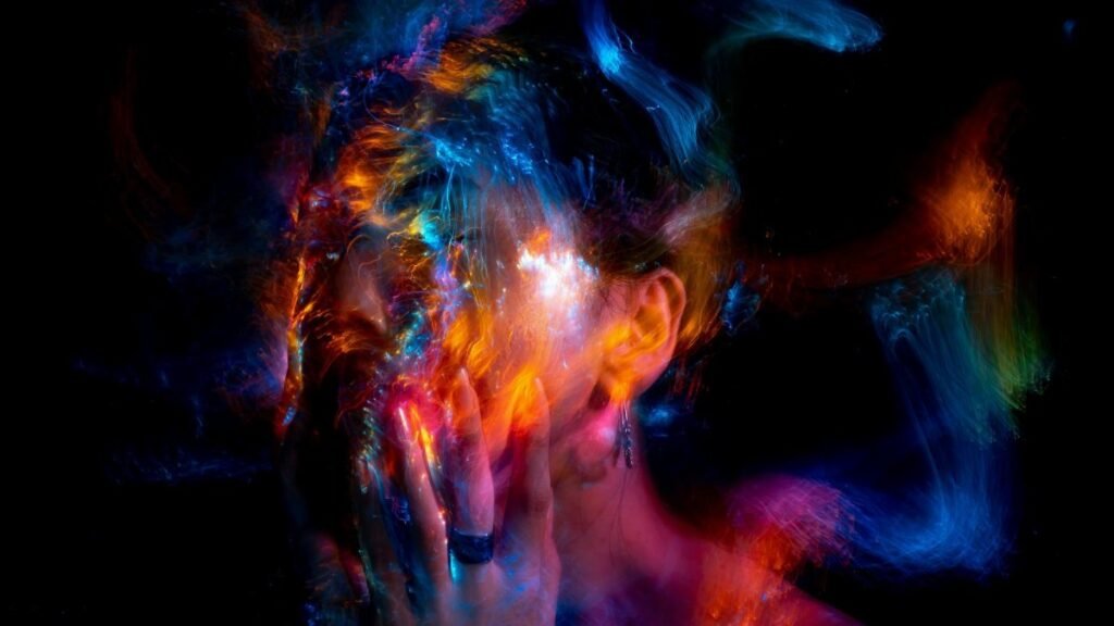 Vibrant long exposure portrait with colorful light painting effects.