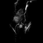 Two people silhouetted engaging in a deep conversation, dramatic lighting.