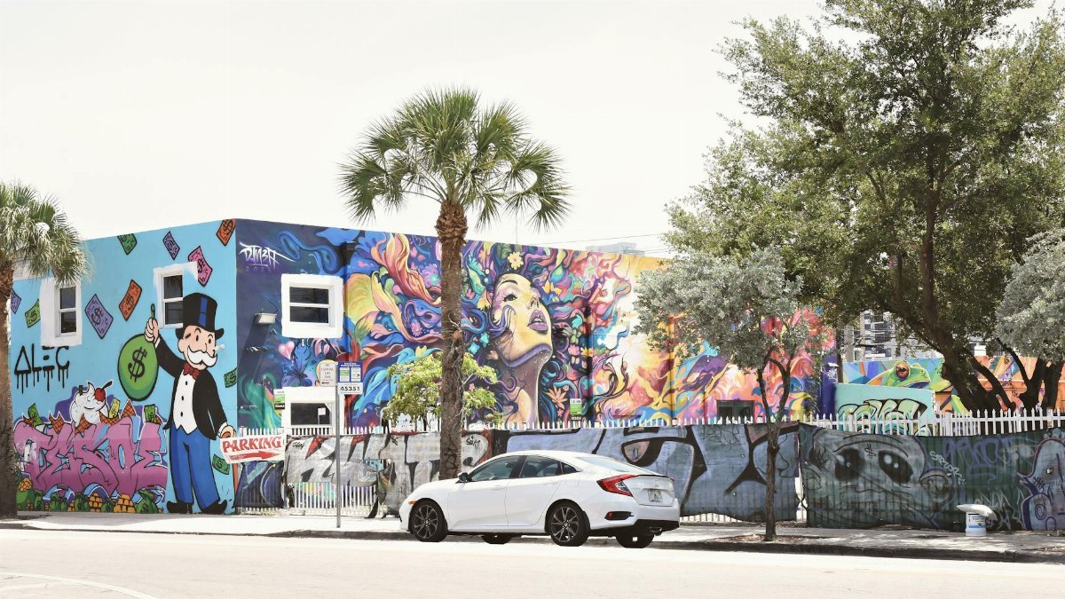 Colorful street art in Miami's urban environment featuring vivid graffiti and mural artwork.