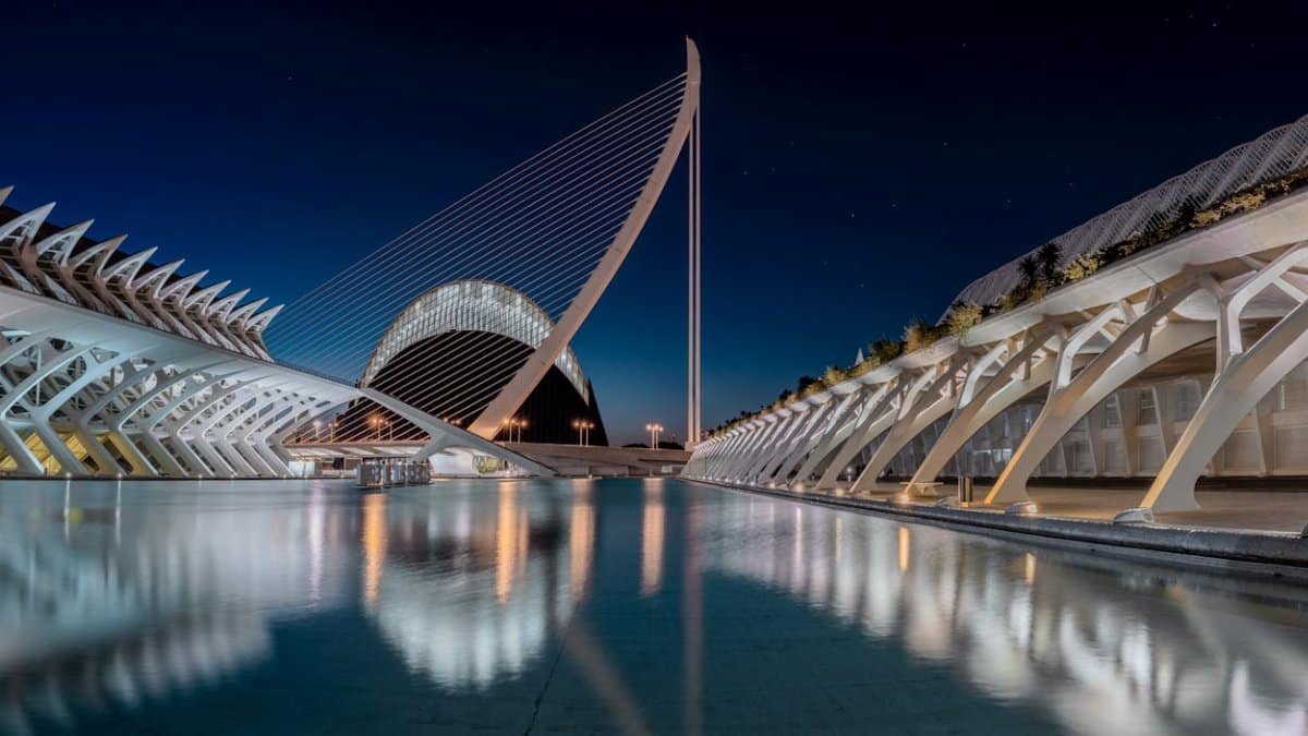 Stunning night view of Valencia's futuristic architecture reflecting in water.