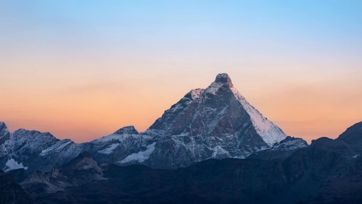 Captivating view of the Matterhorn at sunrise, showcasing vibrant colors and majestic peaks.