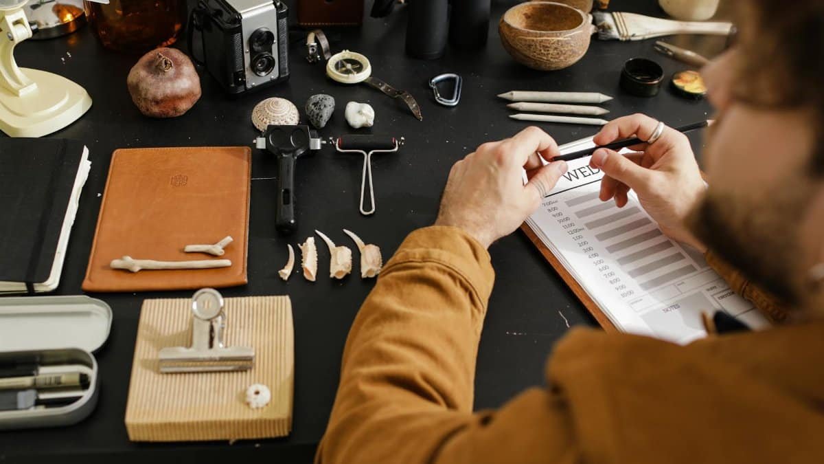 An archaeologist meticulously studies various fossils, highlighting detailed research and examination.