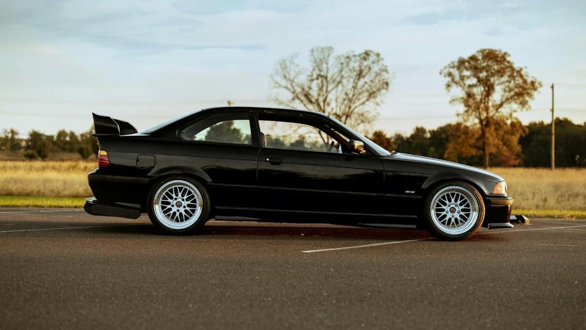 Side view of a stylish black sedan parked outdoors in Philadelphia.