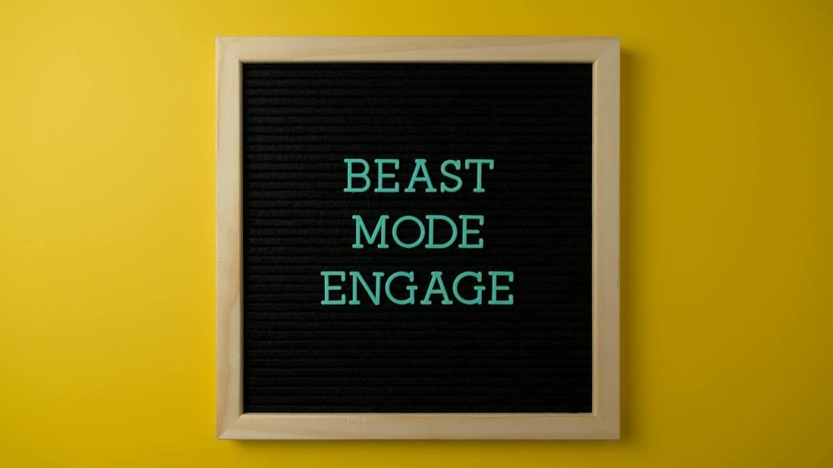 Inspirational letter board with 'Beast Mode Engage' text on vibrant yellow background for motivation.