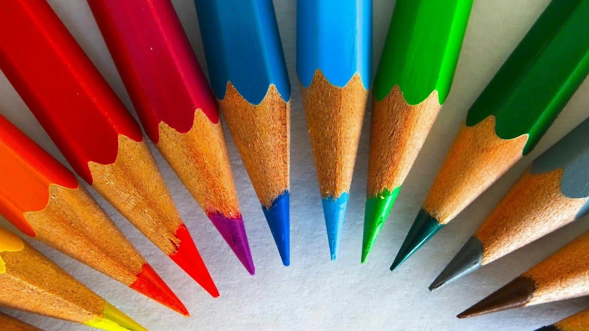 A vivid close-up of sharpened colored pencils arranged in a circular pattern.