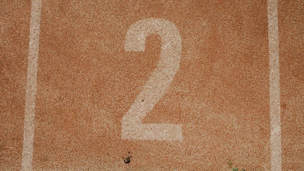 Close-up of number two on a track starting line, perfect for sports themes.