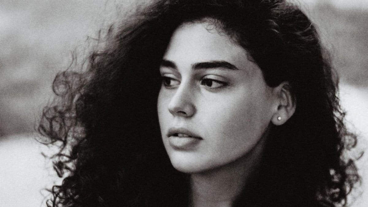 Artistic black and white portrait capturing the elegance and depth of a young woman's expression.