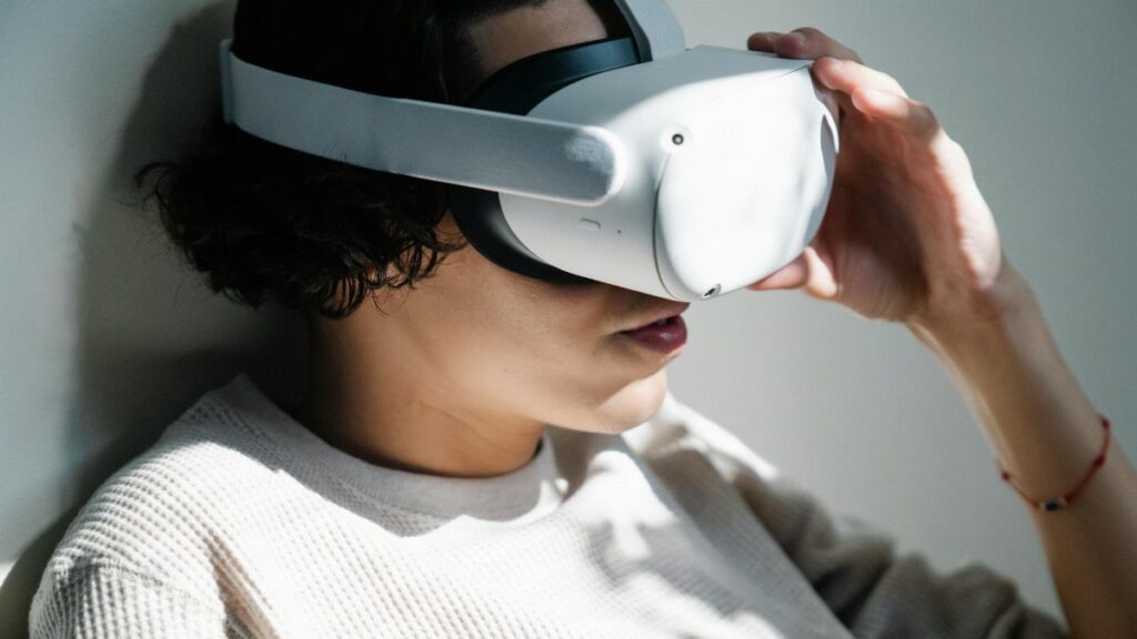 A woman immersed in a virtual reality experience with a VR headset indoors.
