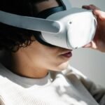 A woman immersed in a virtual reality experience with a VR headset indoors.