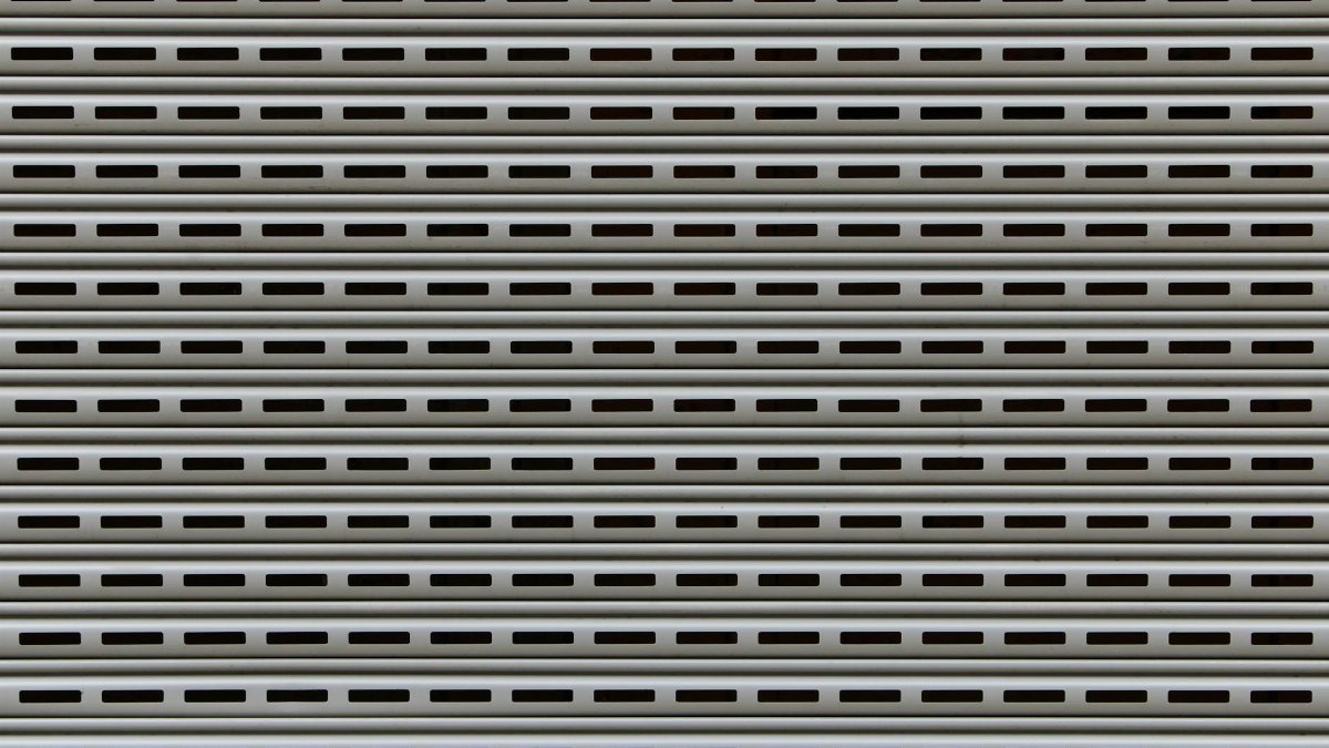 Close-up view of a textured metallic roll-up door showcasing repetitive horizontal patterns.