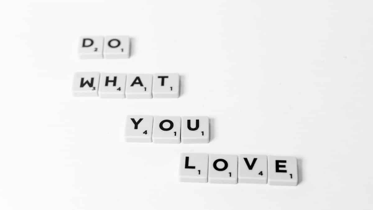 Scrabble tiles spelling 'Do What You Love' on a minimalist white background.