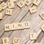 Scattered wooden letter tiles on a rustic wood surface highlighting the word 'Mind'. Ideal for mental and cognitive themes.