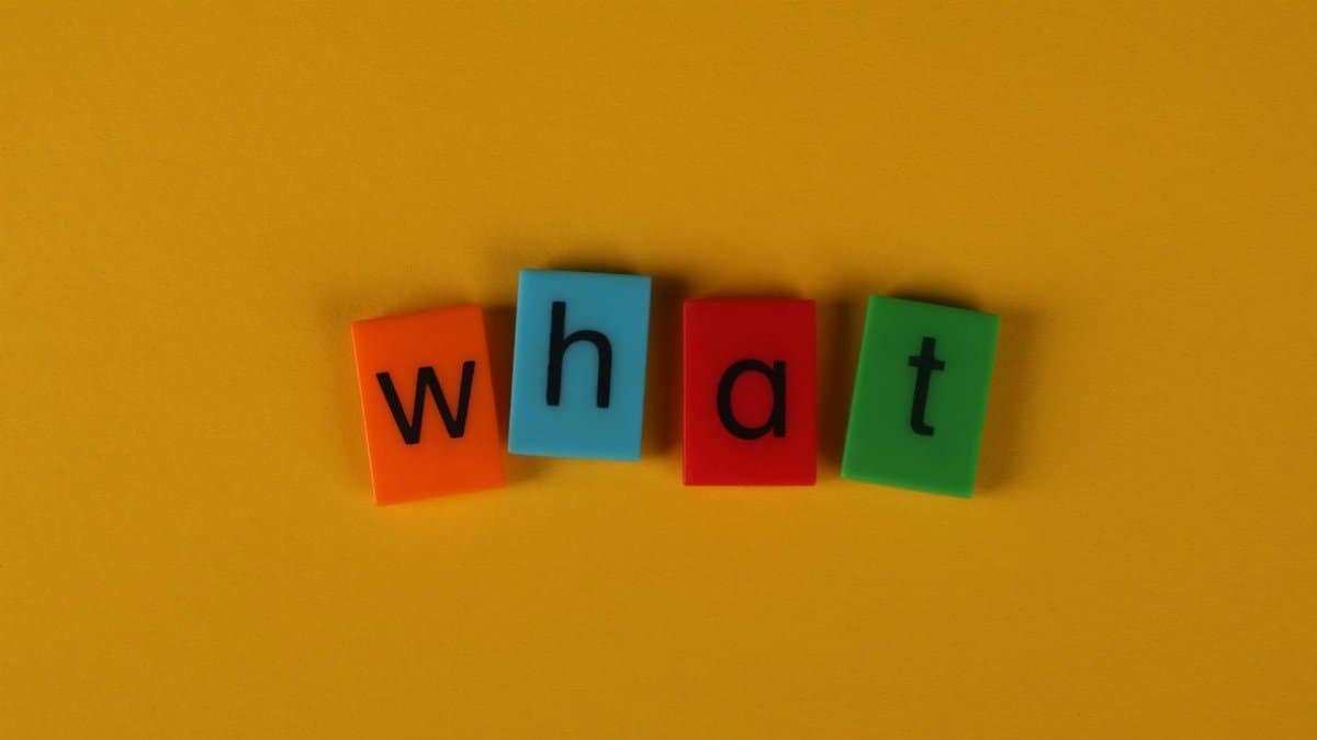 Colorful blocks spelling 'What' on a bright yellow background, creating a playful and bold composition.