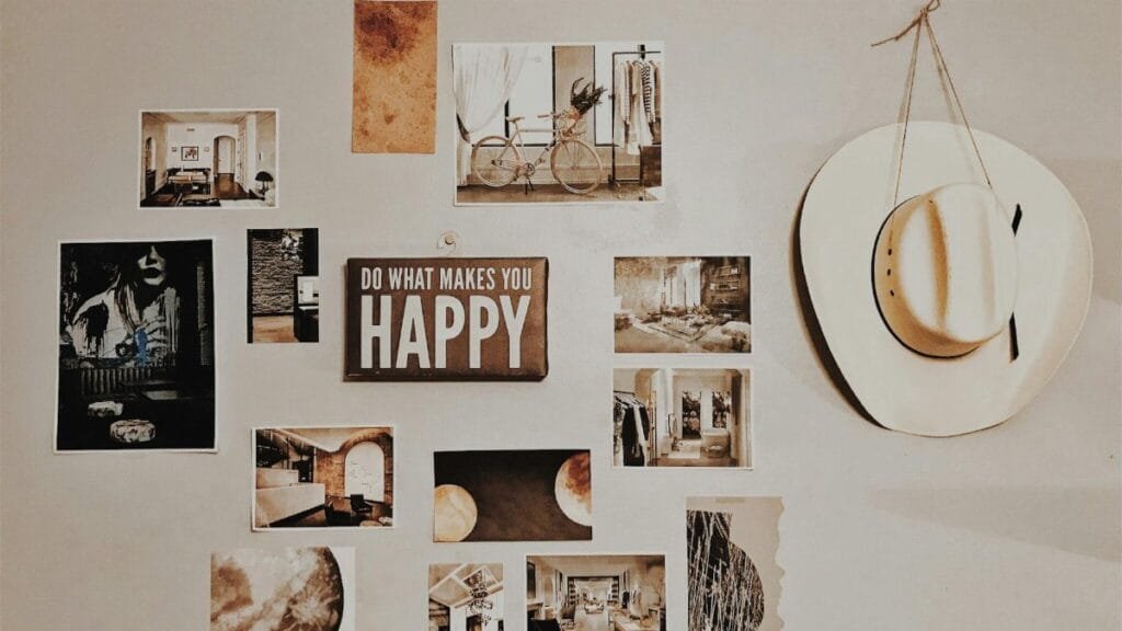 Gallery wall with photos, art, and an inspirational sign, featuring a cowboy hat.