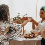 Three women practicing a spiritual ritual indoors, fostering connection and balance.