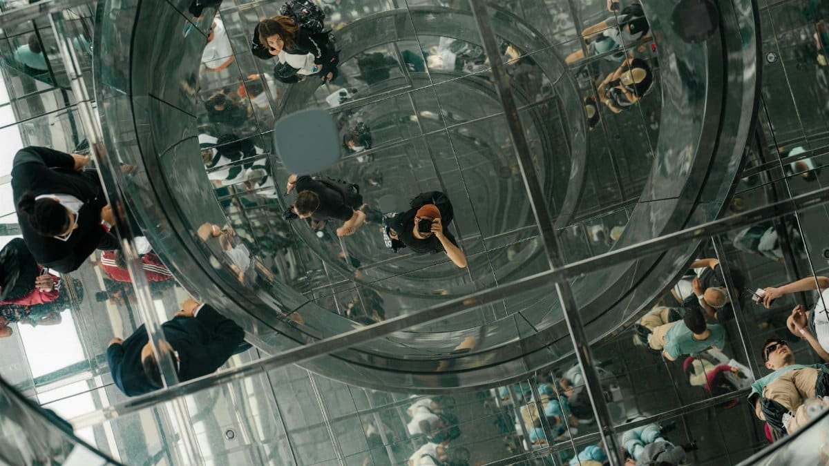 A stunning view of reflections and modern architecture at Summit One Vanderbilt in NYC.
