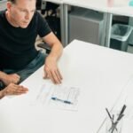 A couple discusses legal documents with a professional in a modern office setting.
