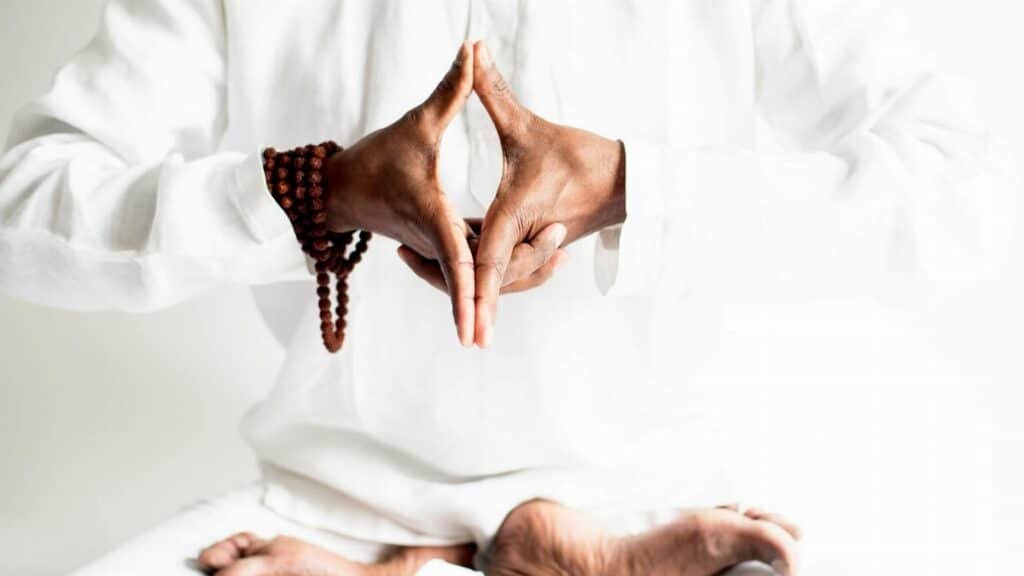 A peaceful yoga practice focused on meditation and balance, captured in serene white tones.