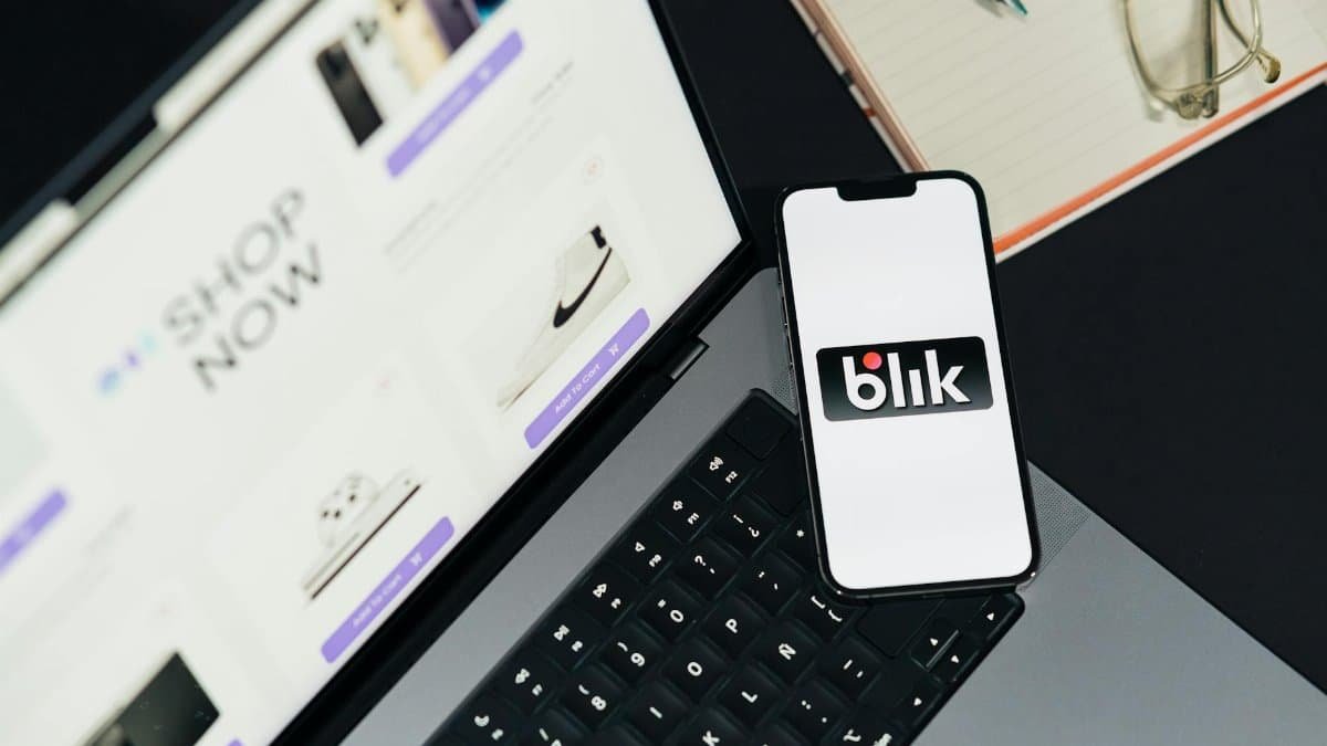 A laptop and smartphone displaying online shopping platforms, hinting at e-commerce trends.