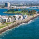 Stunning drone shot of San Diego's coastline, showcasing urban cityscape and ocean views.