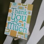 Close-up of a thank you card with money tucked behind, perfect for showing gratitude.