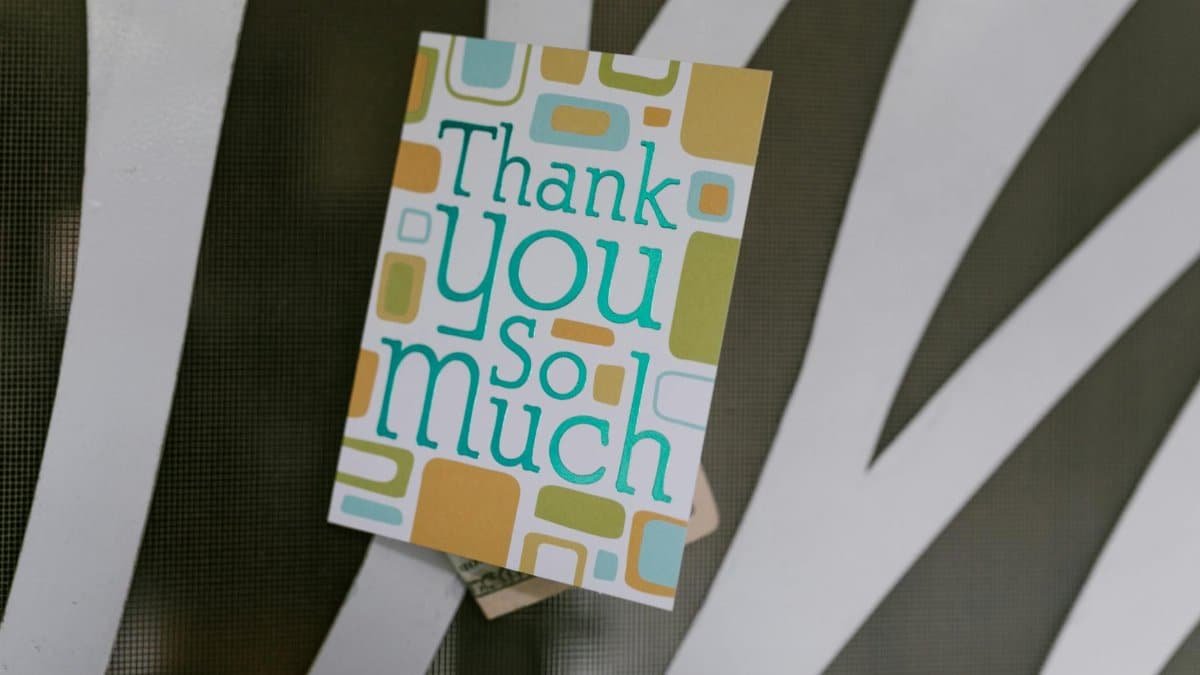Close-up of a thank you card with money tucked behind, perfect for showing gratitude.