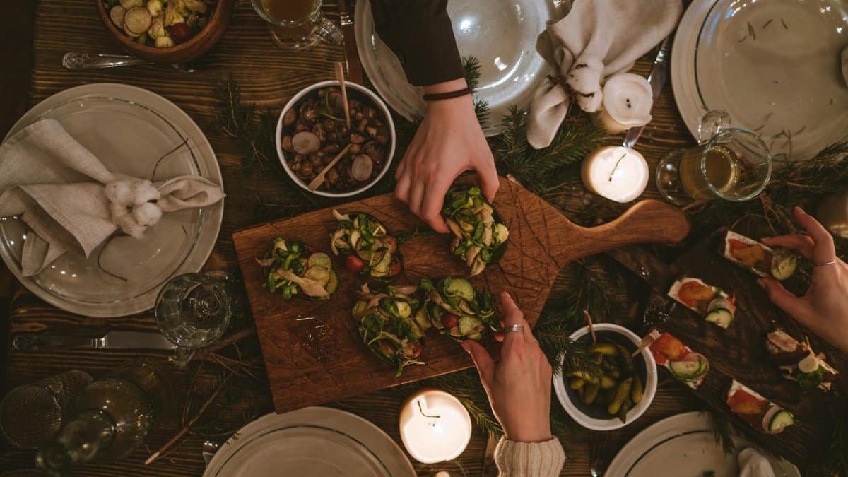 Warm and inviting holiday table with festive decorations and appetizers.
