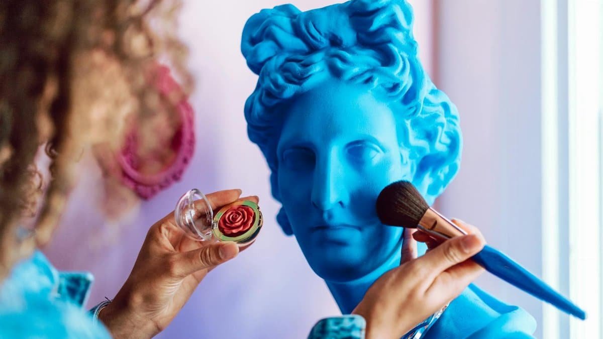 A vibrant reinterpretation of a classical sculpture with modern makeup application.