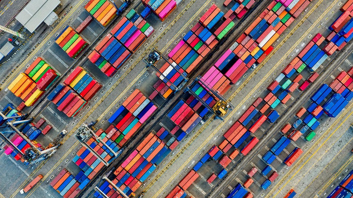 Aerial view of vibrant shipping containers at a busy Jakarta port, showcasing global trade.