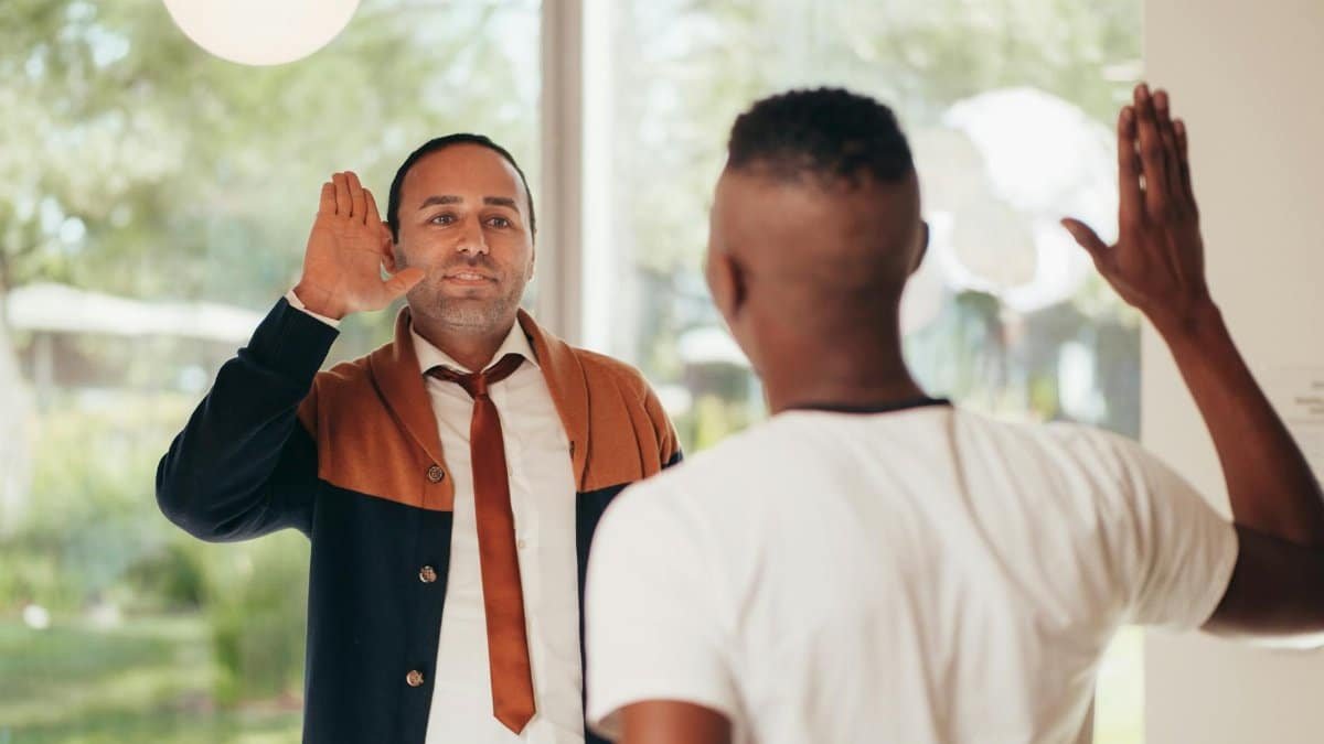 Two diverse business colleagues exchanging a high five in an office setting.
