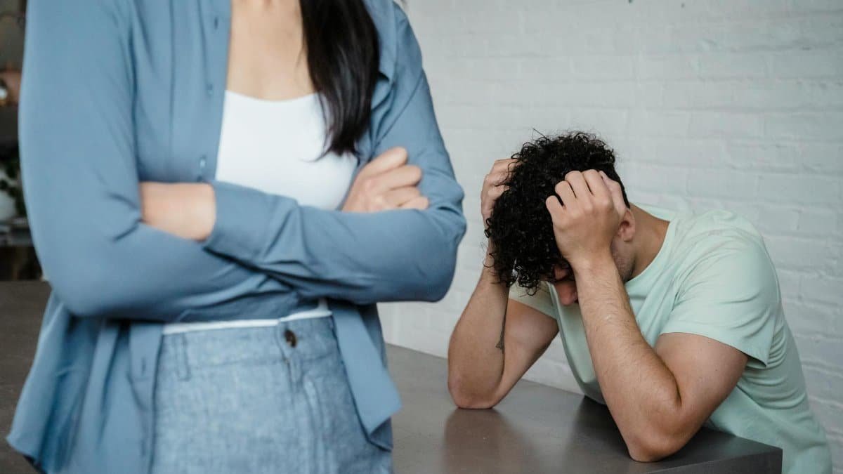 A couple experiencing relationship stress and conflict in an indoor setting, illustrating discord and tension.