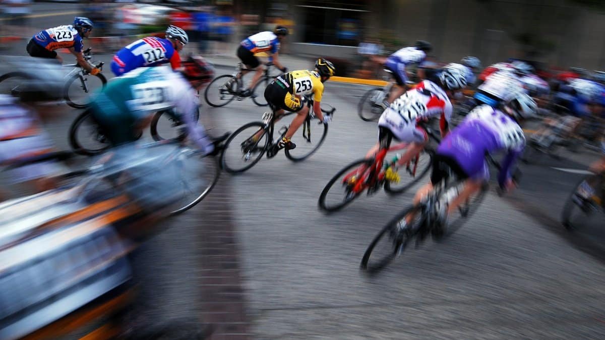 Exciting panning shot of a group of cyclists racing with motion blur.