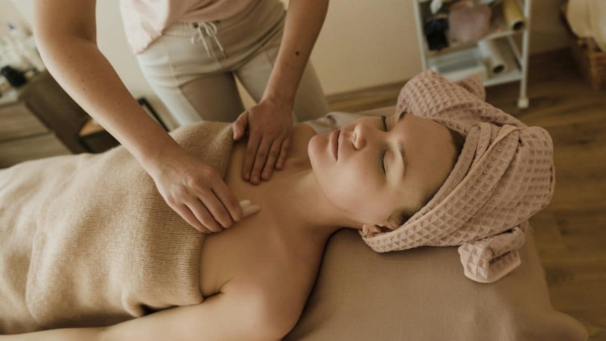 A serene spa setting with a woman enjoying a skin care treatment. Ideal for wellness concepts.