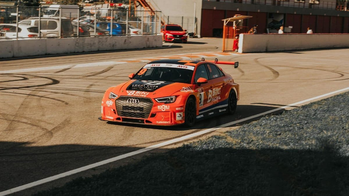 Audi RS 3 racecar on a sunny day at a Turkish racetrack showing speed and performance.