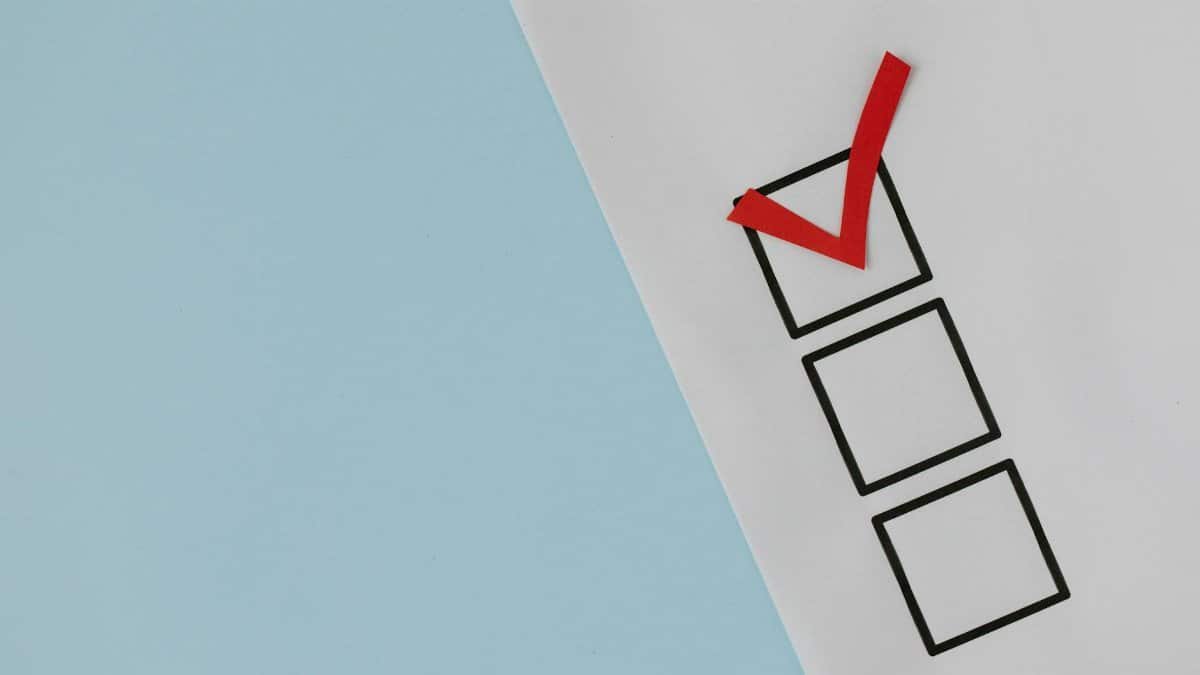 A simple white paper checklist with one red checkmark, ideal for concepts like completion or approval.